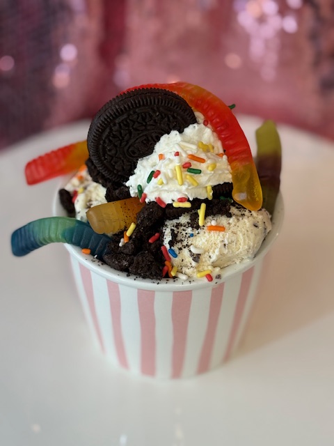 Cookies and cream sundae with gummy worms, Oreos, and sprinkles.